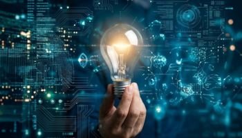 Glowing lightbulb held in hand